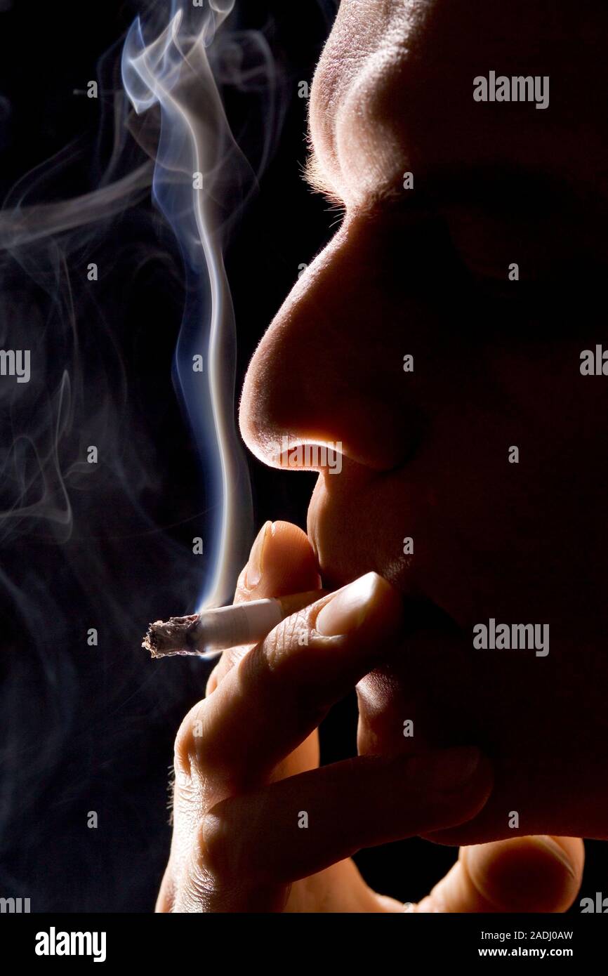 Man smoking. Cigarettes contain the addictive drug nicotine and cancer
