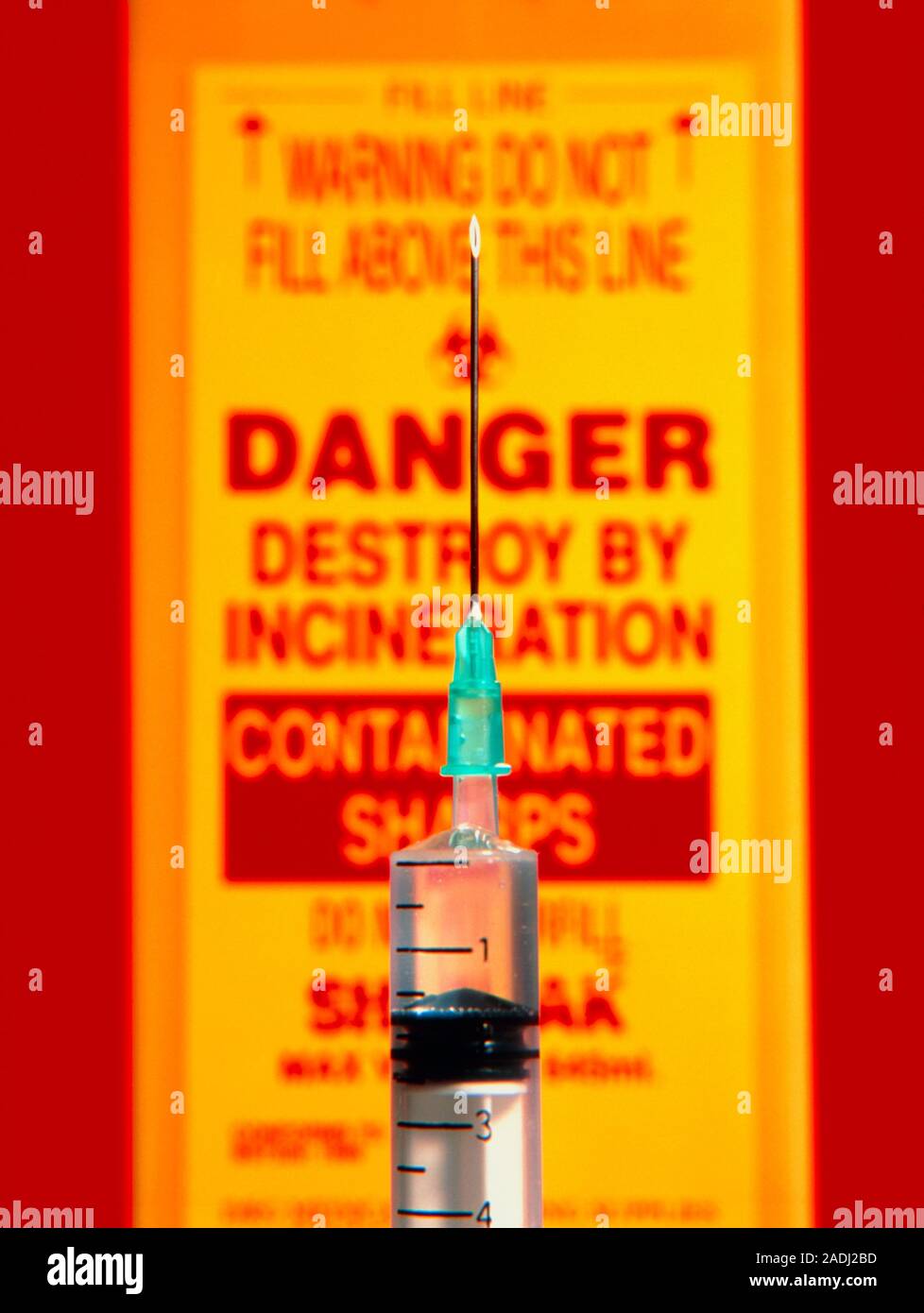 Syringe. Closeup of a hypodermic syringe pointing upwards in front of