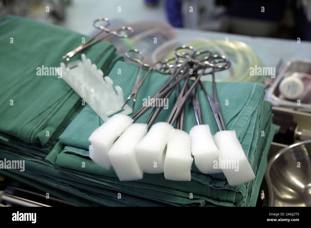 Surgical swabs. Absorbent swabs prepared for use during an operation. The forceps will hold