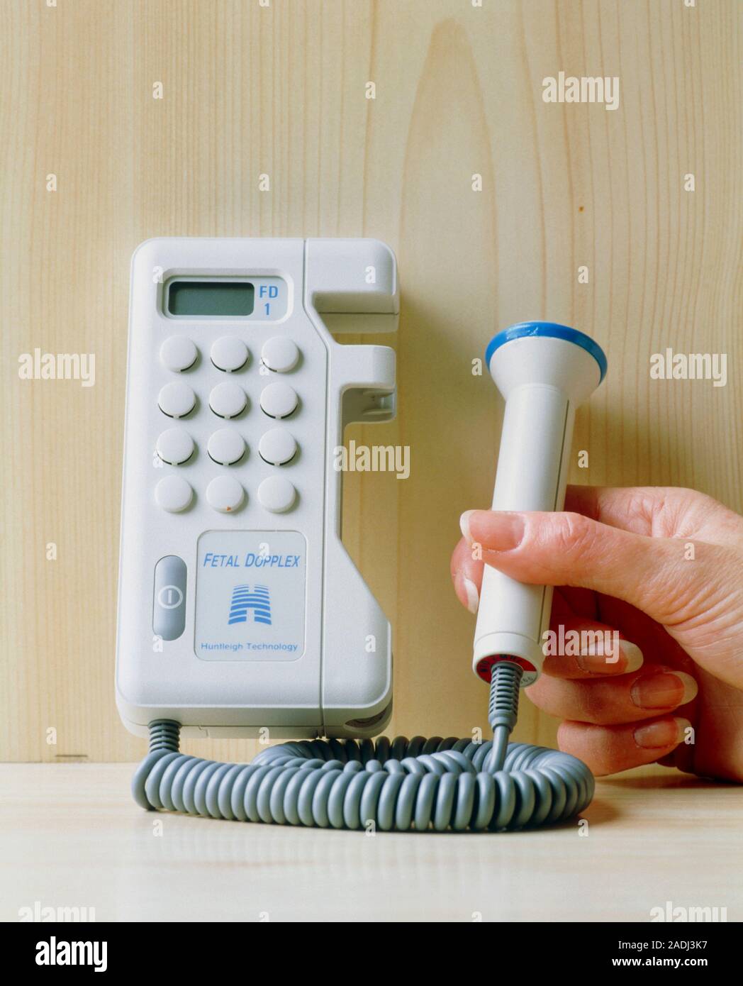 Foetal doppler ultrasound. Hand holding the transducer of a portable