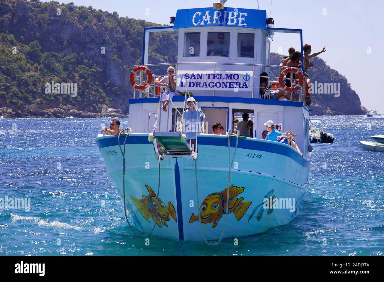 Tourists on a pleasure vessel at tiny Pantaleu island, San Telmo, Mallorca, Balearic islands, Spain Stock Photo