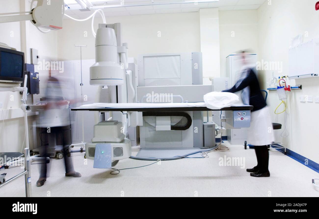 Xray equipment. Radiographers preparing Xray equipment for use in the