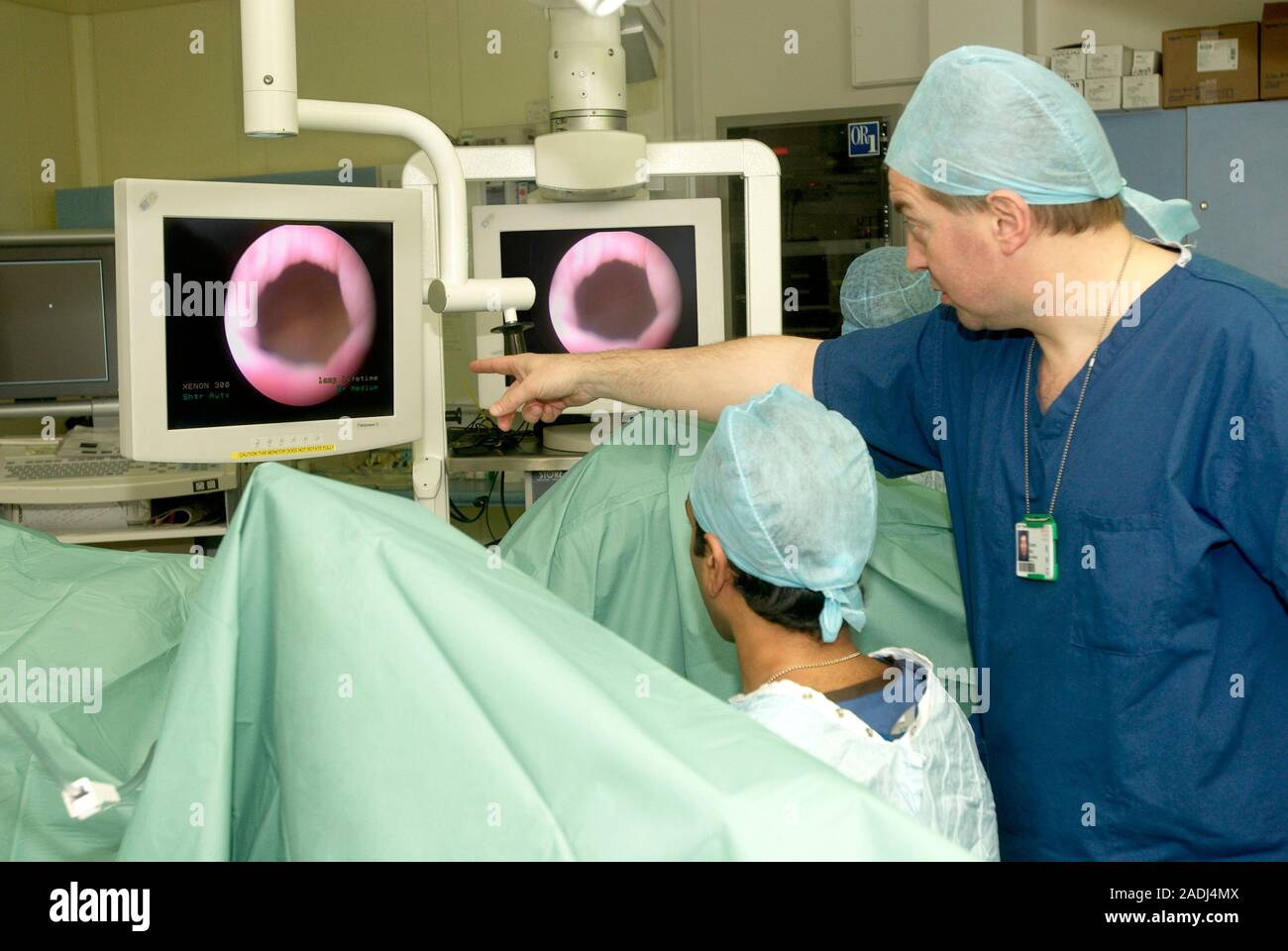 MODEL RELEASED. Endoscopy. Consultant surgeon guiding a student through