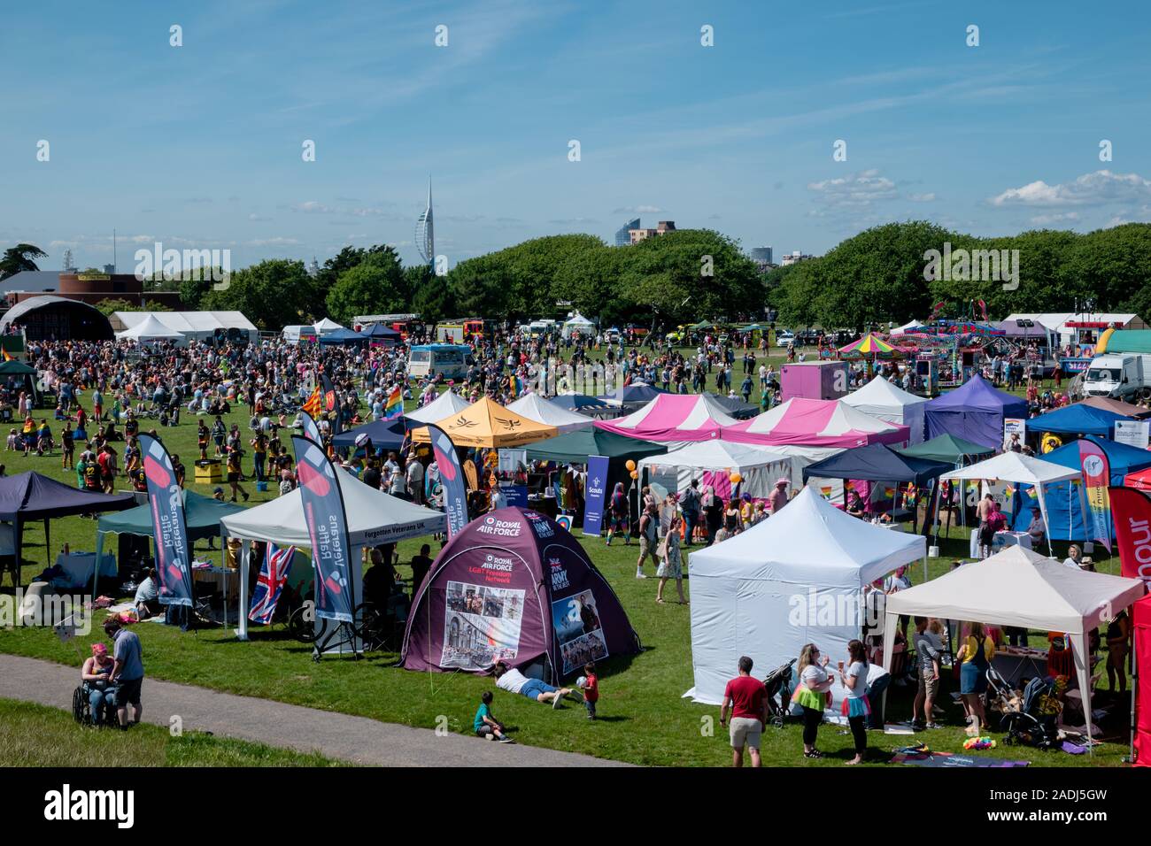 Crowds gather for Portsmouth Pride in Southsea to celebrate the LGBTQ+ community, with stalls and stands and stage performance Stock Photo
