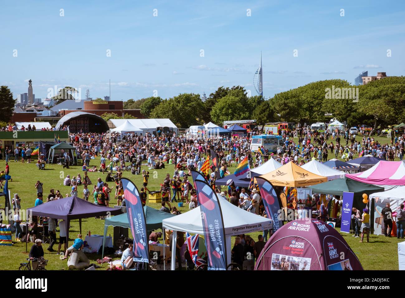 Crowds gather for Portsmouth Pride in Southsea to celebrate the LGBTQ+ community, with stalls and stands and stage performance Stock Photo
