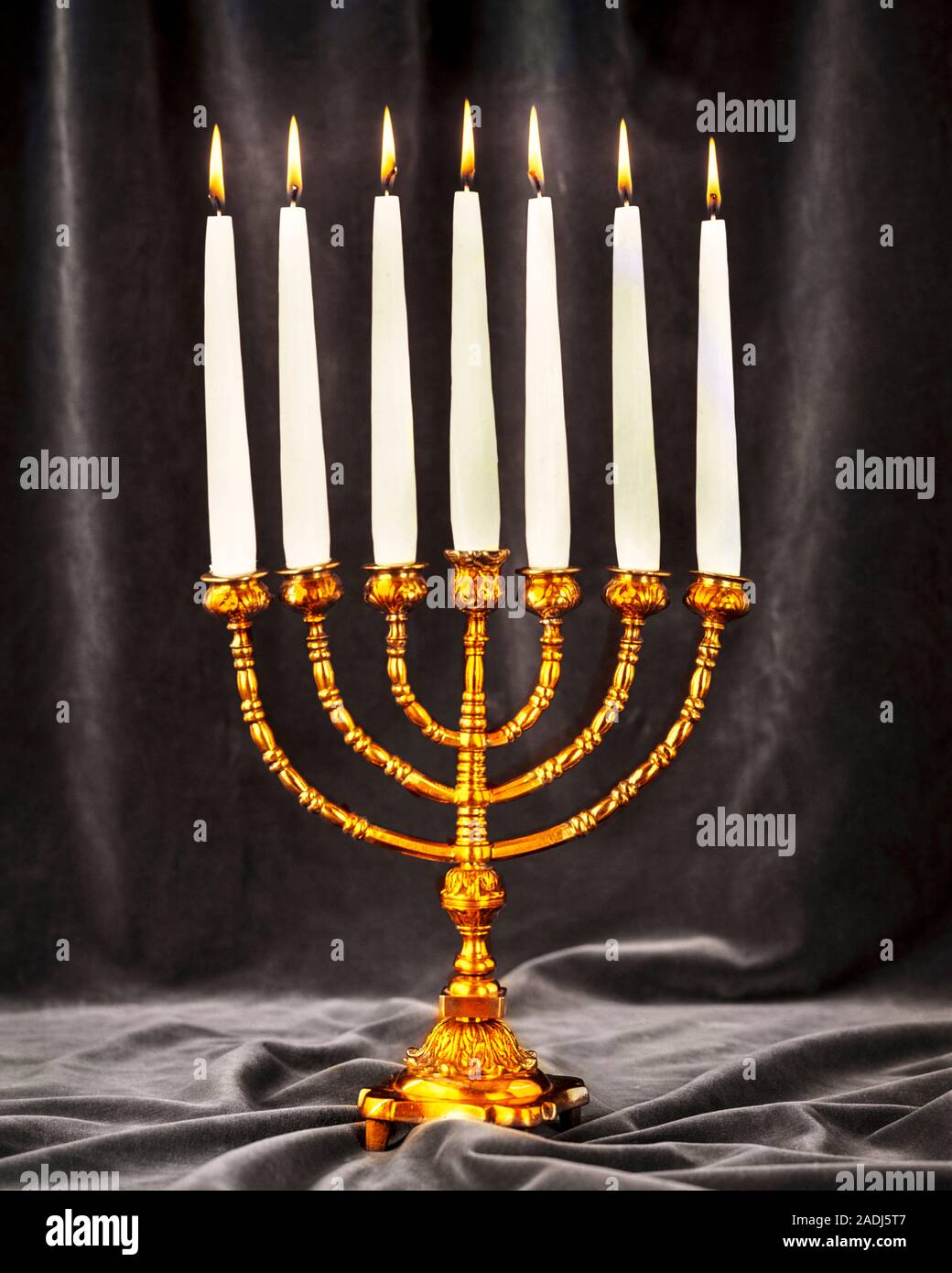 1980s A GOLDEN OR BRASS MENORAH ANCIENT SYMBOL OF JEWISH FAITH WITH 7 BRANCHES AND CANDLES - kr29439 PHT001 HARS OLD FASHIONED REPRESENTATION Stock Photo