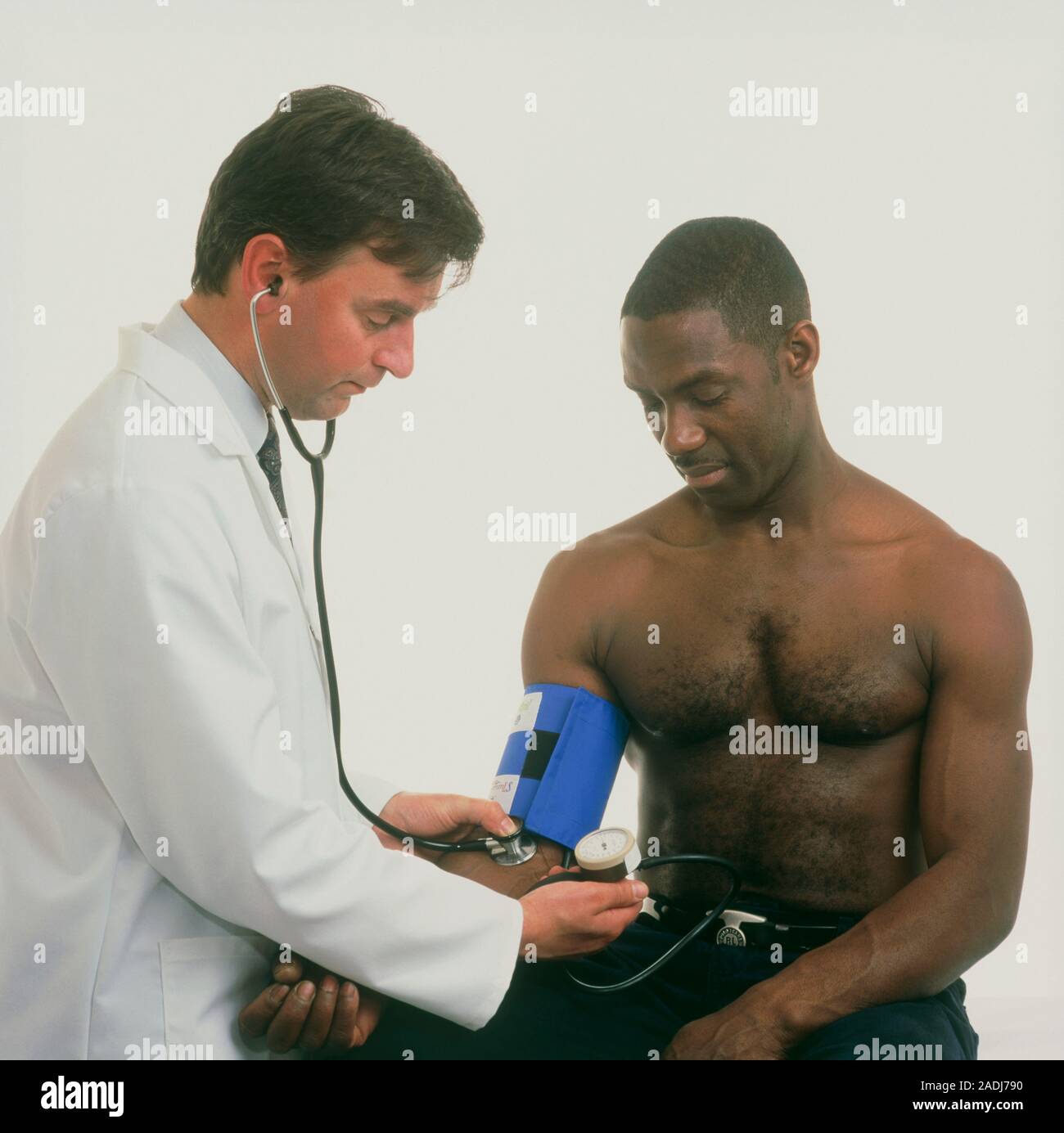 Blood pressure measurement. Man having his blood pressure taken by a