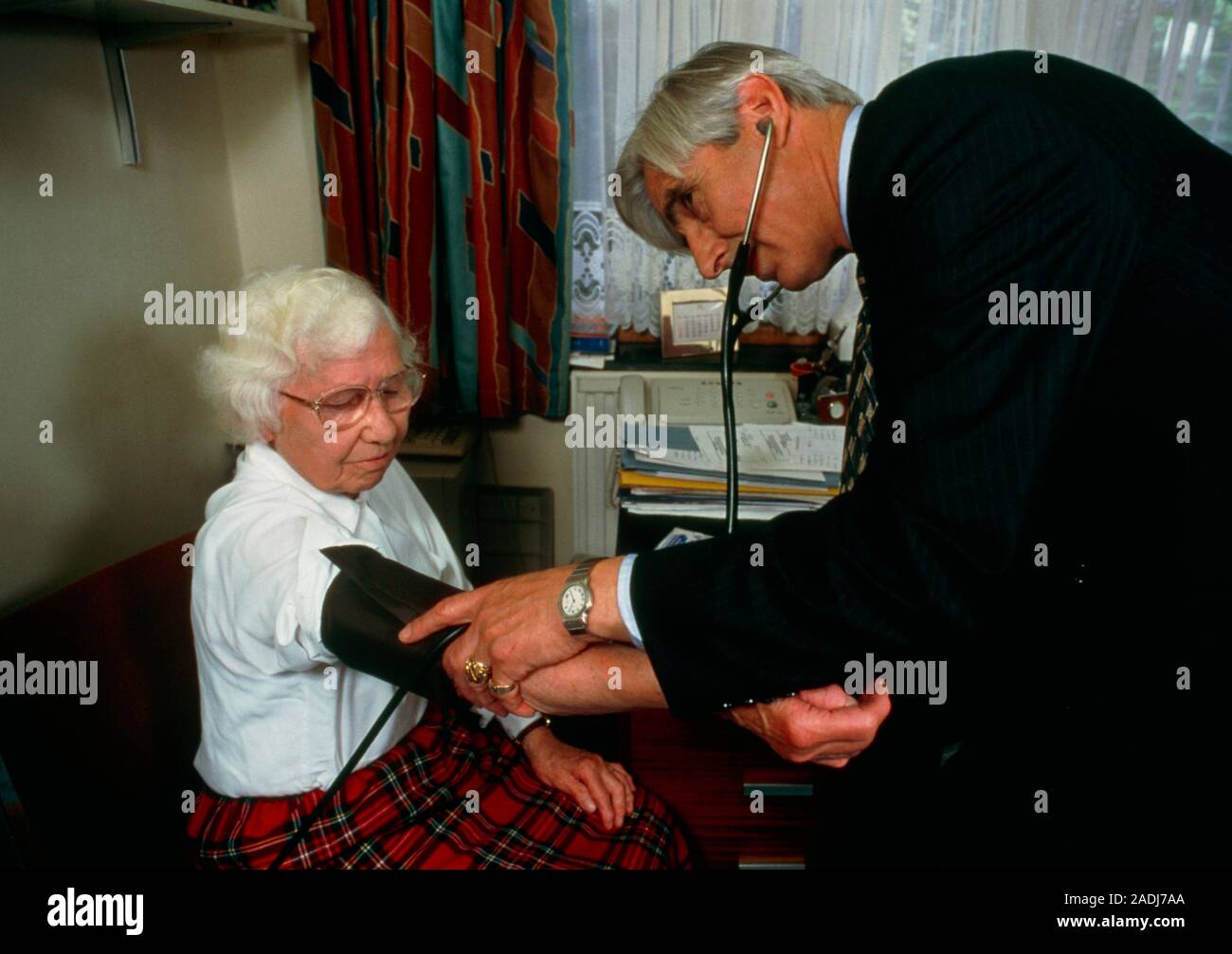 Blood pressure measurement. Doctor using a sphygmomanometer to take a ...