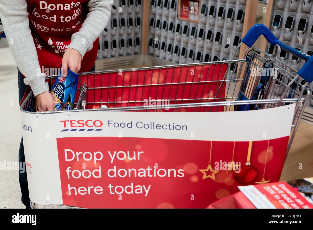 A Volunteer Sorts Donations In A Trolley At The Tesco Supermarket