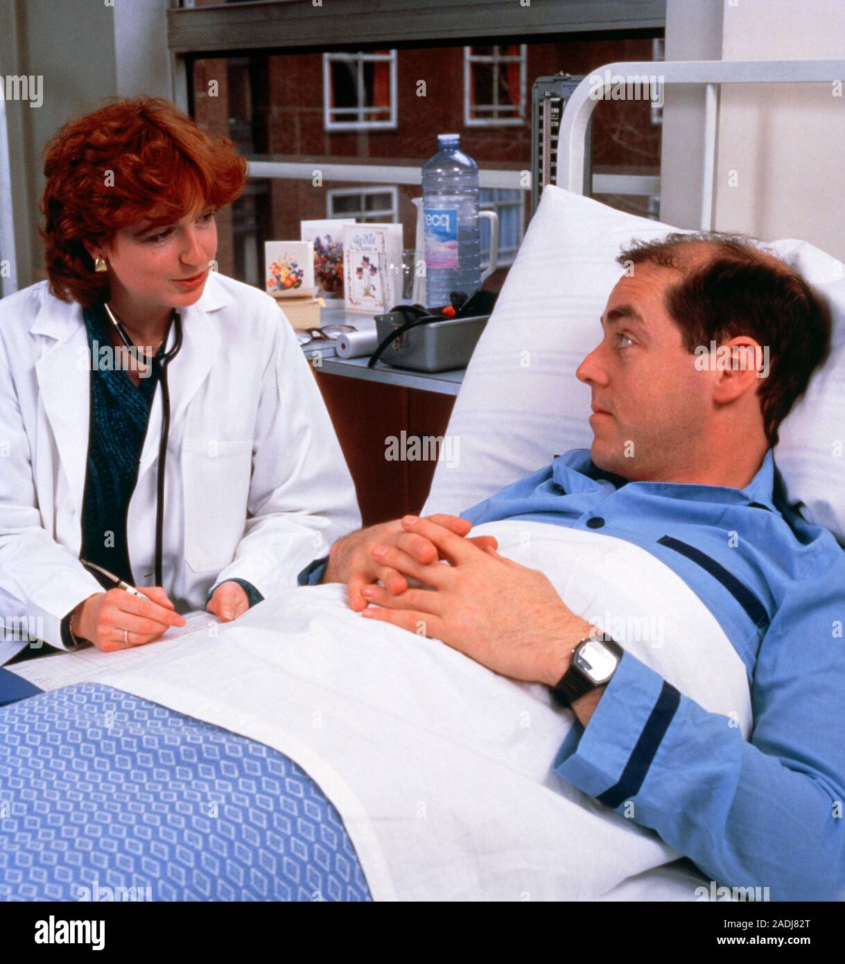 MODEL RELEASE AVAILABLE. Bedside manner hospital doctor talking to a