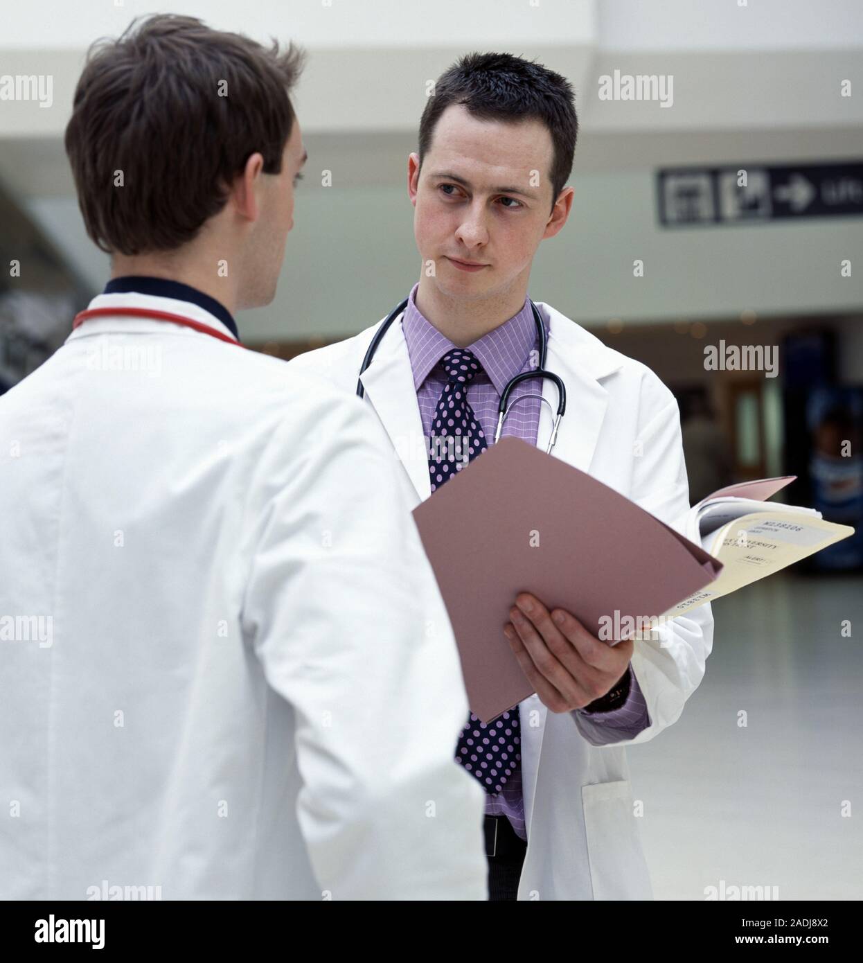 Hospital doctors discussing a patient's notes. Stock Photo