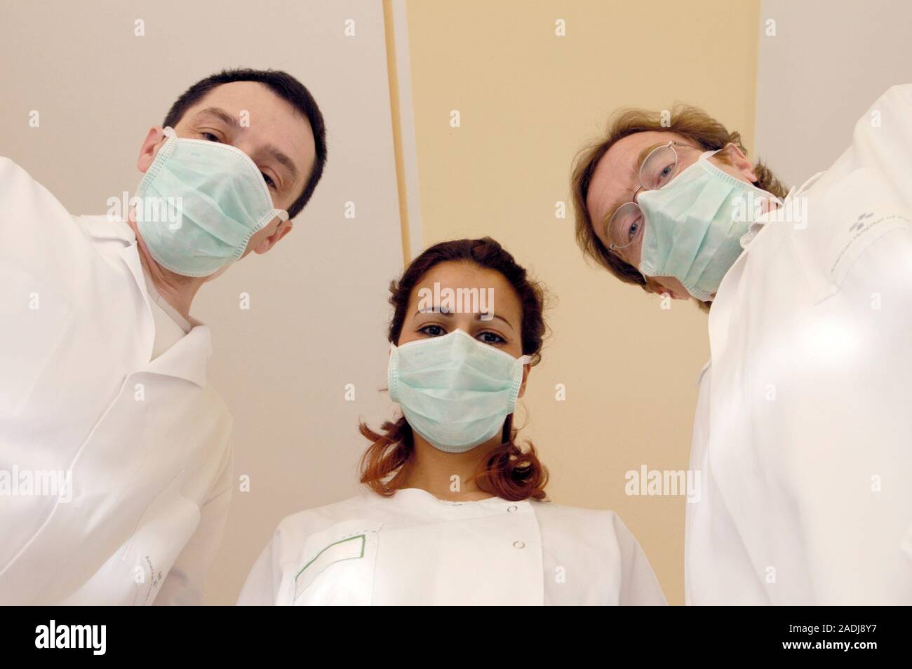 MODEL RELEASED. Three doctors wearing face masks. Stock Photo