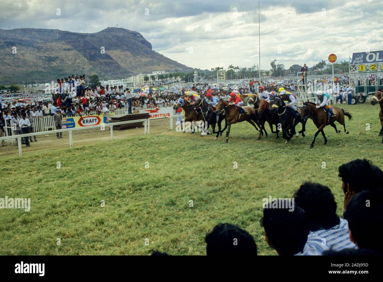 Champ de Mars Racecourse in Port Louis, Mauritius 1987. The horses sprint off watched by the crowds. Stock Photo