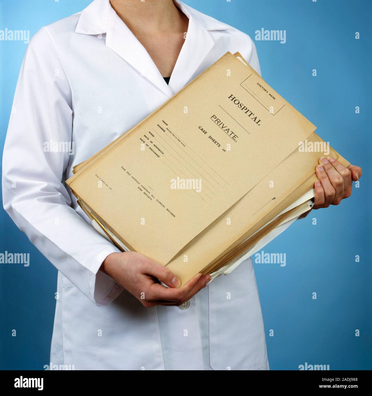 Medical records. Nurse carrying a pile of medical records. This could