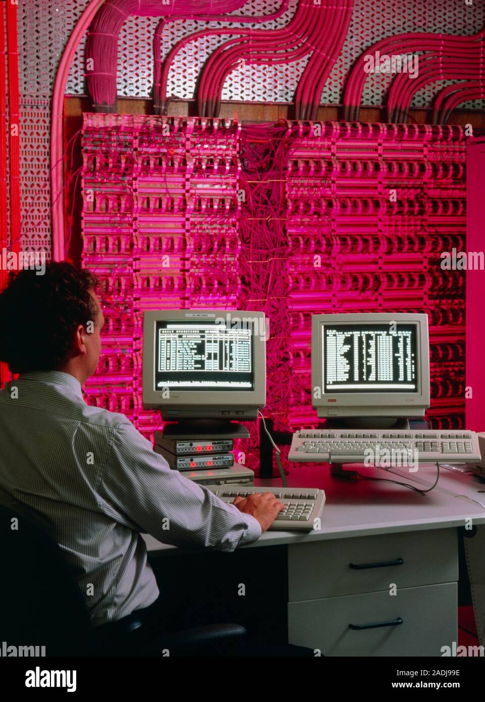 Control room in paperless hospital. A technician sits at computer