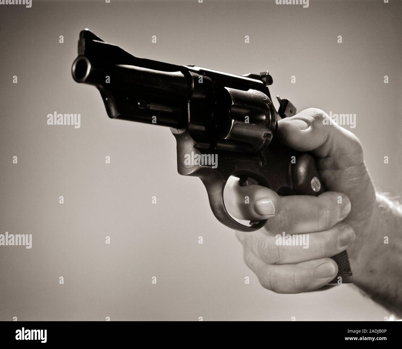 Robbery in store. Robber is aiming and threatening with gun in shop. Stock  Photo