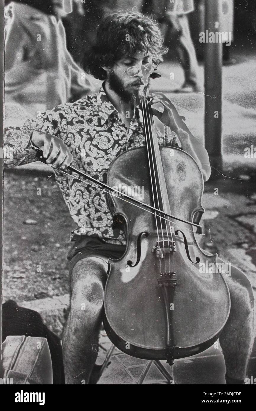 Fine black and white art photography from the 1970s of a street musician playing the string bass Stock Photo