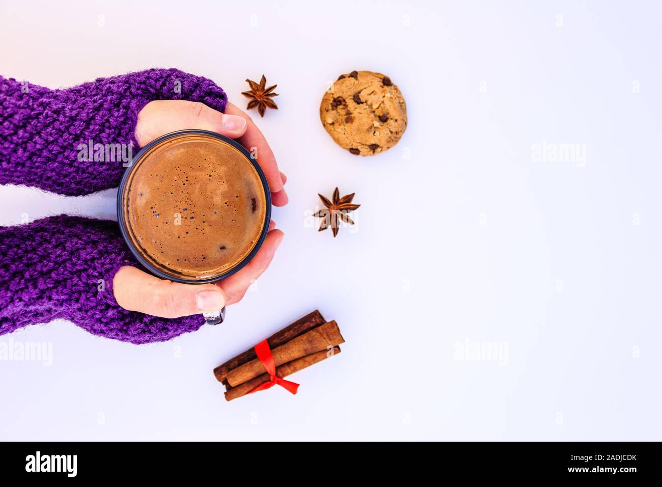 Female hands holding hot chocolate  on a white background. Stock Photo