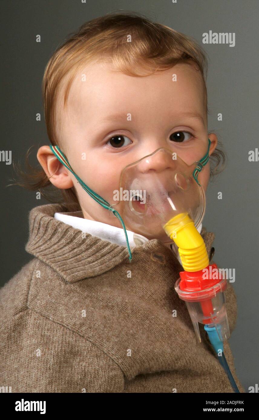 MODEL RELEASED. Oxygen therapy. Young boy wearing an oxygen mask. The