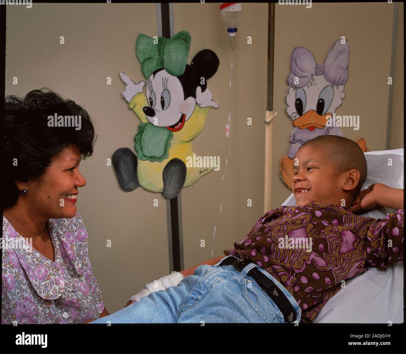Child undergoing chemotherapy. A young cancer patient undergoing chemotherapy in a hospital ward