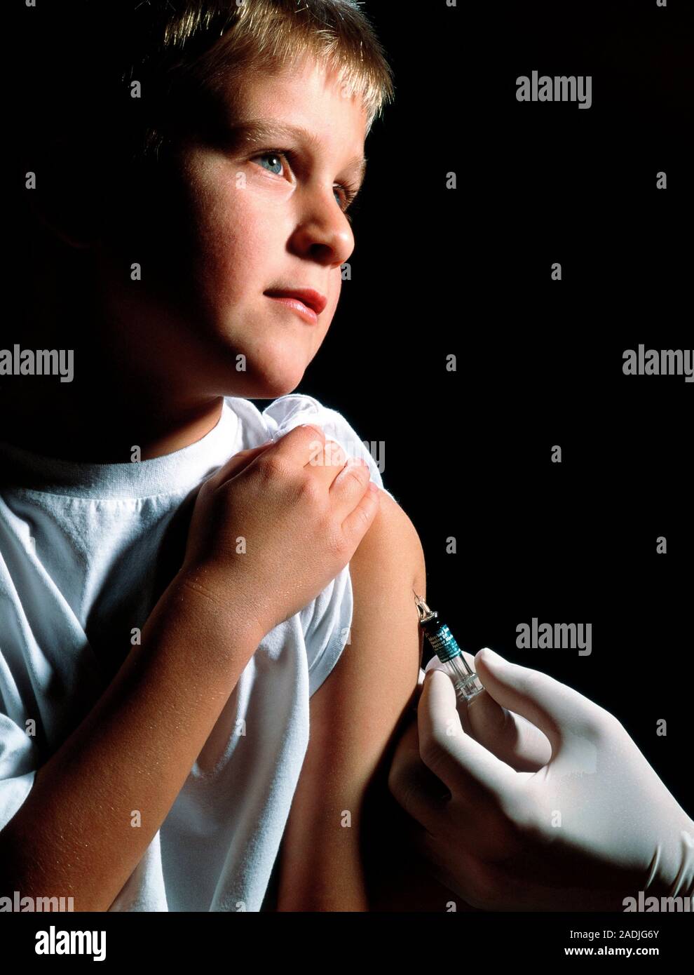 Tetanus booster. Boy, aged 5-10, receiving a tetanus (lockjaw) booster ...