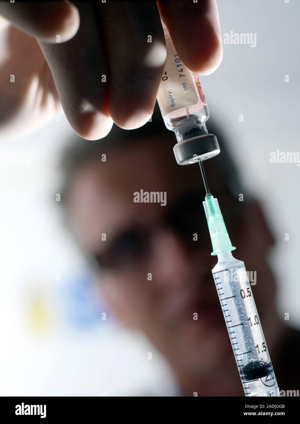 Making Random Injection Preparing an injection. Doctor drawing a drug into a syringe from an ...