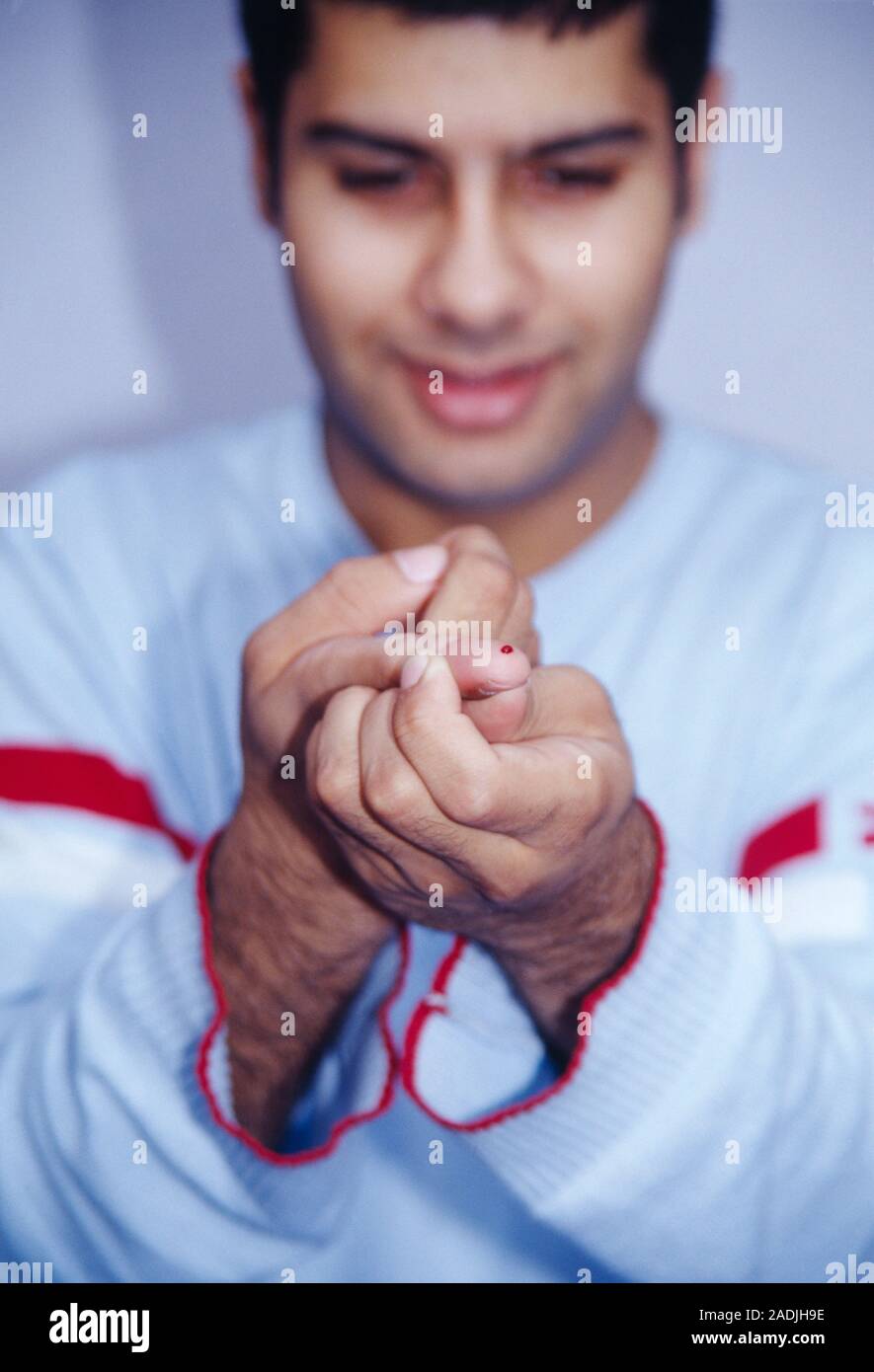Blood glucose test. Drop of blood on a patient's finger. This blood will be smeared on a testing