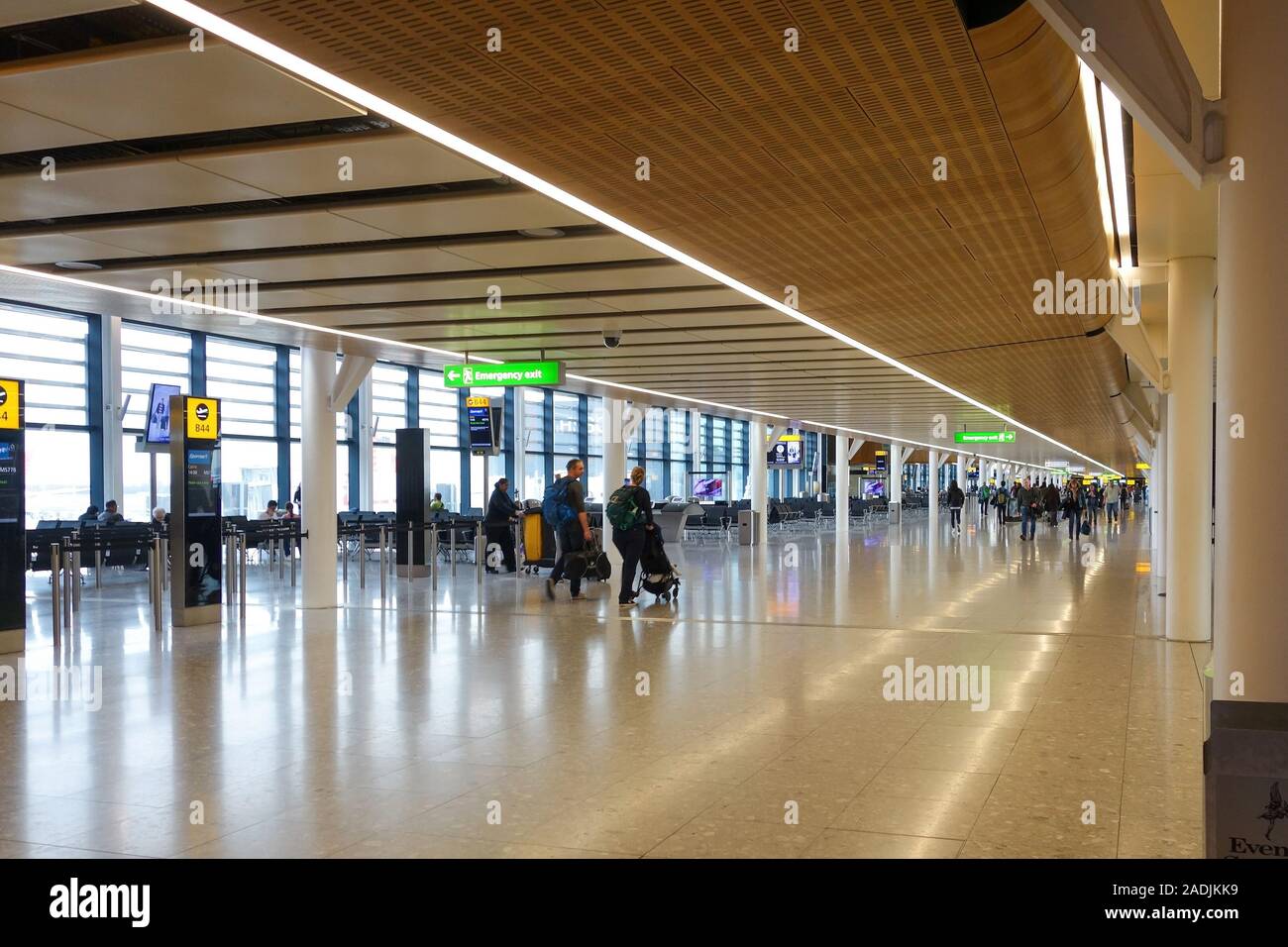 A long corridor and departure gates at Terminal 2 at Heathrow Airport, London, England, UK Stock Photo