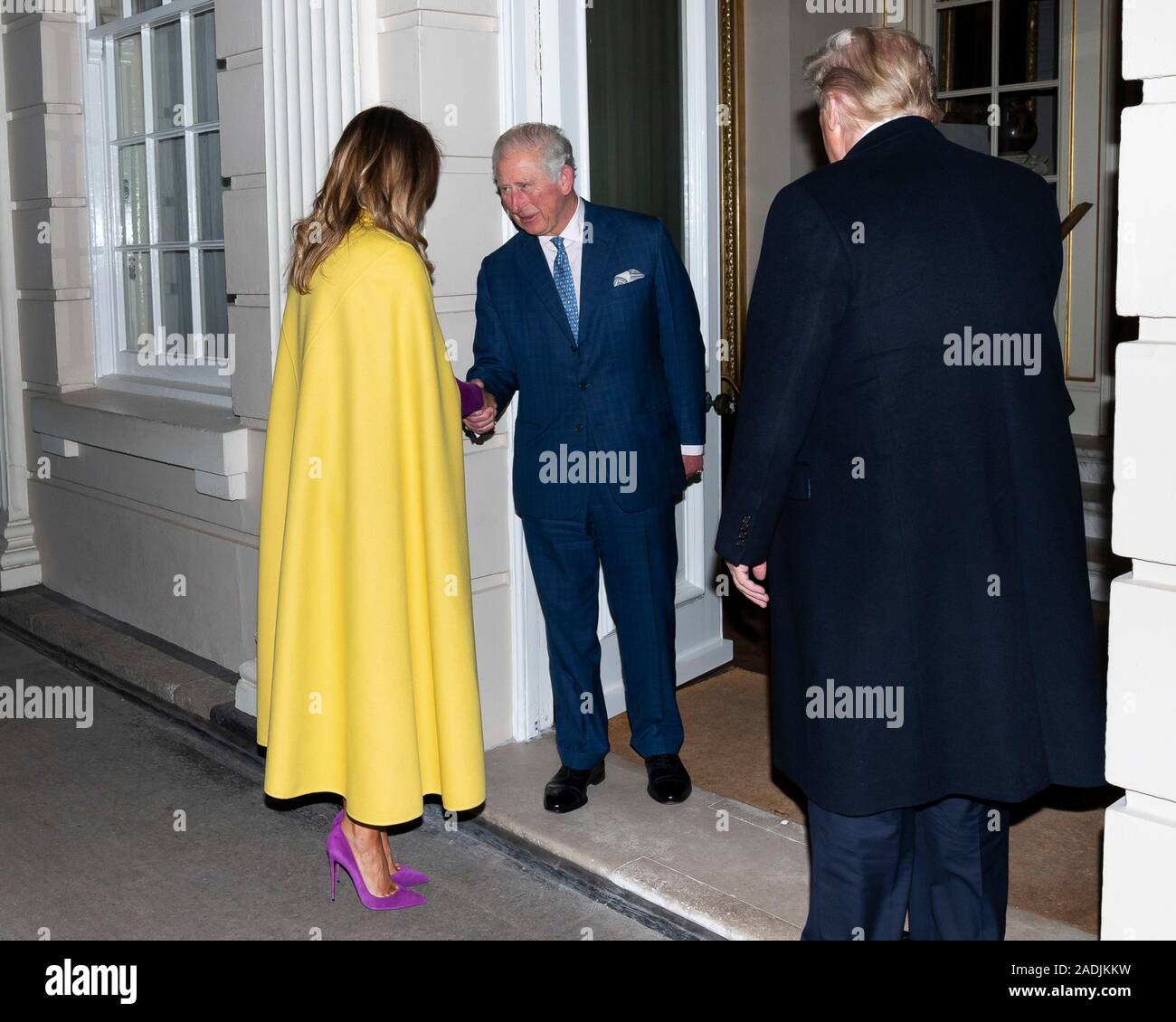 London, United Kingdom. 03 December, 2019. U.S. First Lady Melania Trump is  welcomed by Prince Charles, Prince of Wales as she and President Donald  Trump, right, arrive at Clarence House ahead of