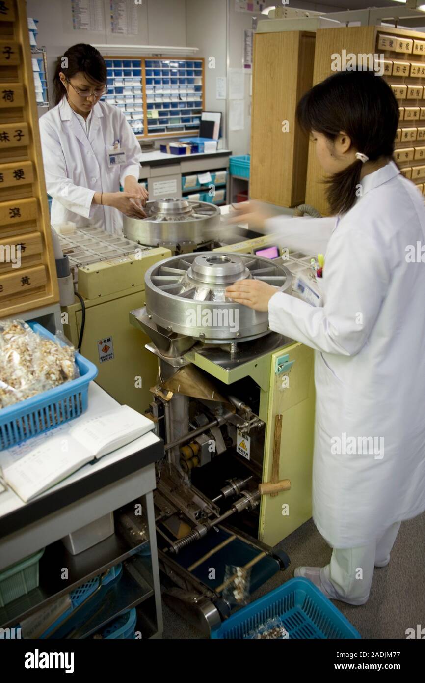MODEL RELEASED. Kampo Japanese traditional medicine. Pharmacists preparing prescriptions of