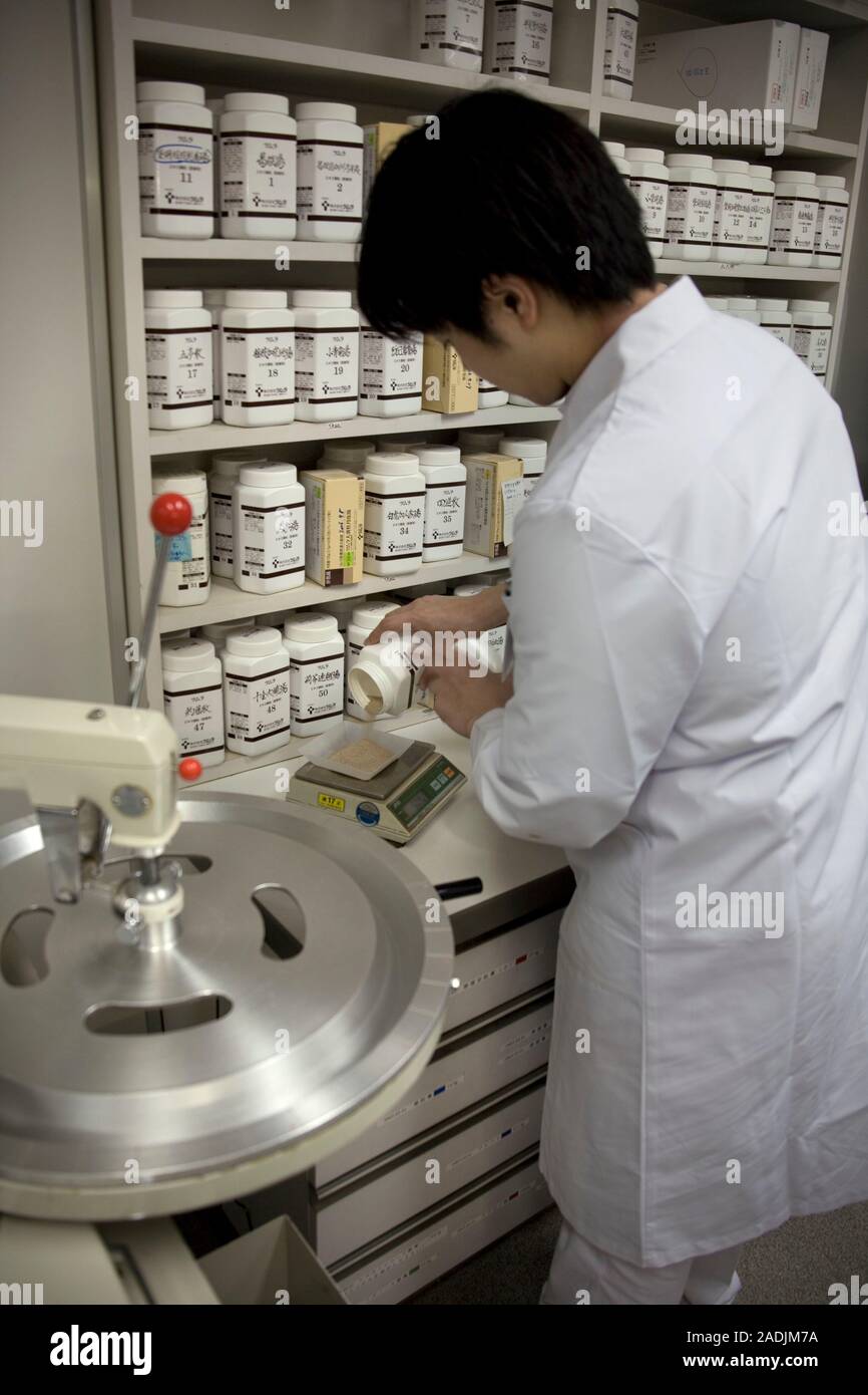 MODEL RELEASED. Kampo Japanese traditional medicine. Pharmacist preparing prescriptions of kampo