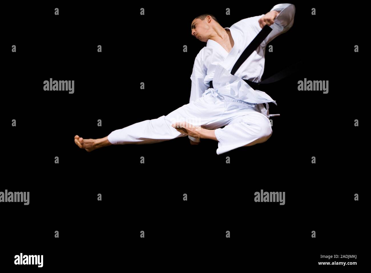 MODEL RELEASED. Karate kick. Karate practitioner performing a jumping
