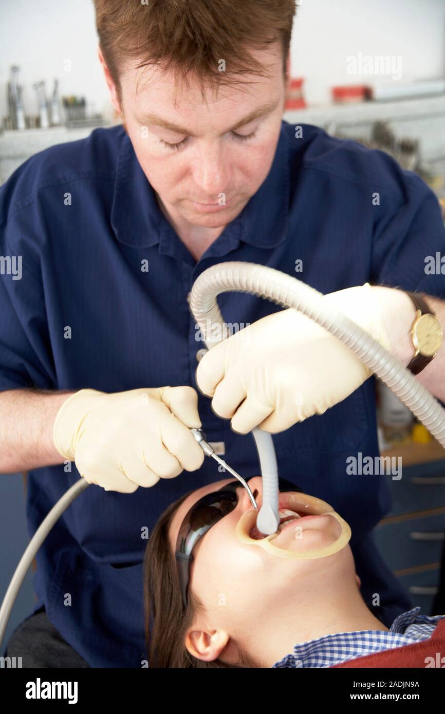 MODEL RELEASED. Orthodontic brace fitting. Image 1 of 3. Orthodontist