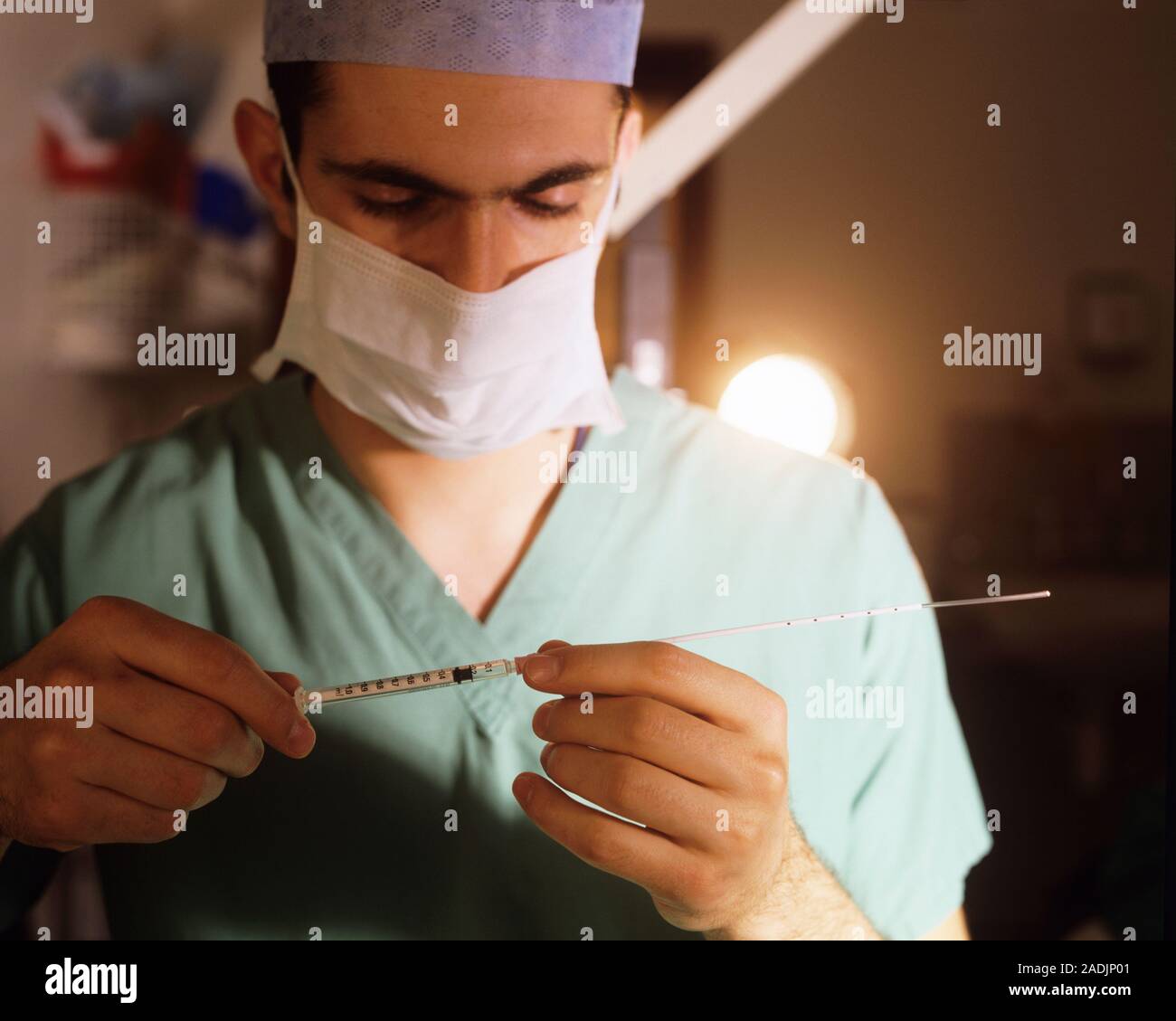 MODEL RELEASED. Embryotransfer catheter. Technician at an in vitro