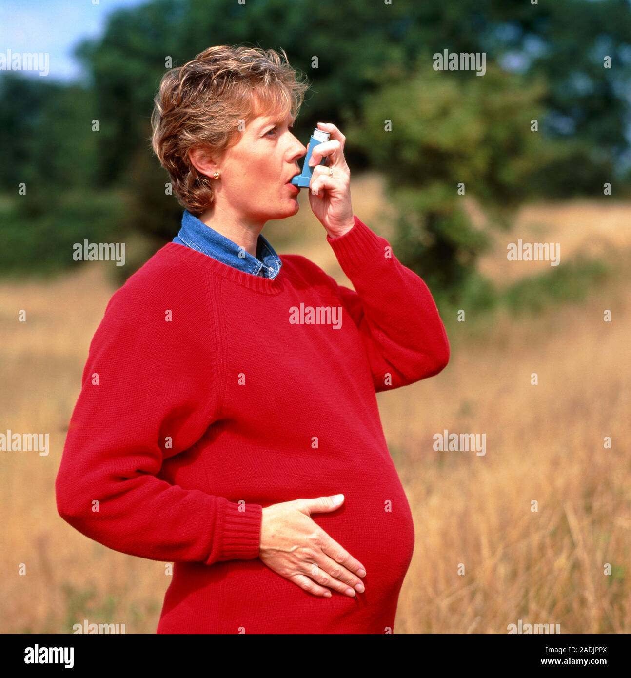 Asthmatic pregnant woman. Pregnant (at about 6 months) woman using a
