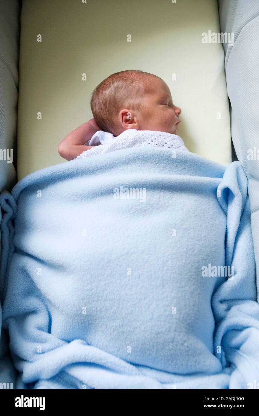 MODEL RELEASED. Newborn baby sleeping in a cot Stock Photo Alamy