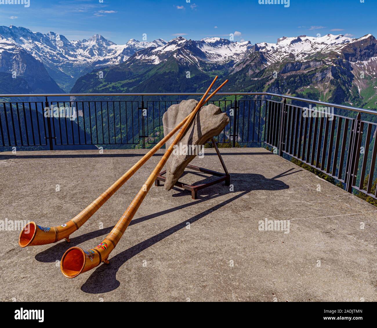 Alpine horn with the Swiss Alps in the background Stock Photo