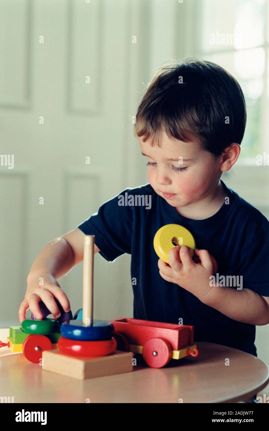 Boy playing. Young boy playing with his toys Stock Photo - Alamy