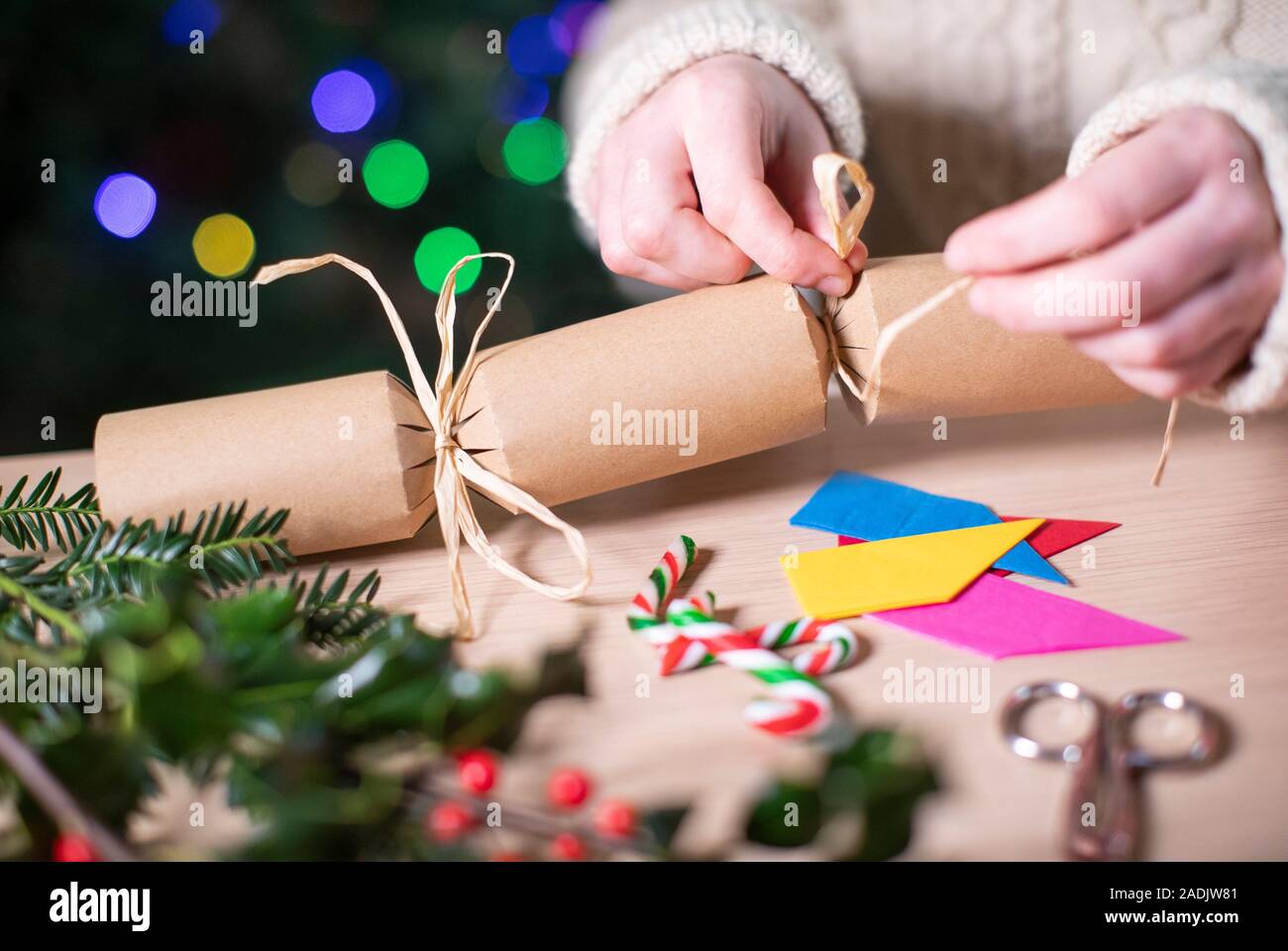Close Up Of Woman Making Homemade Eco Friendly Christmas Cracker From Sustainable Materials Stock Photo