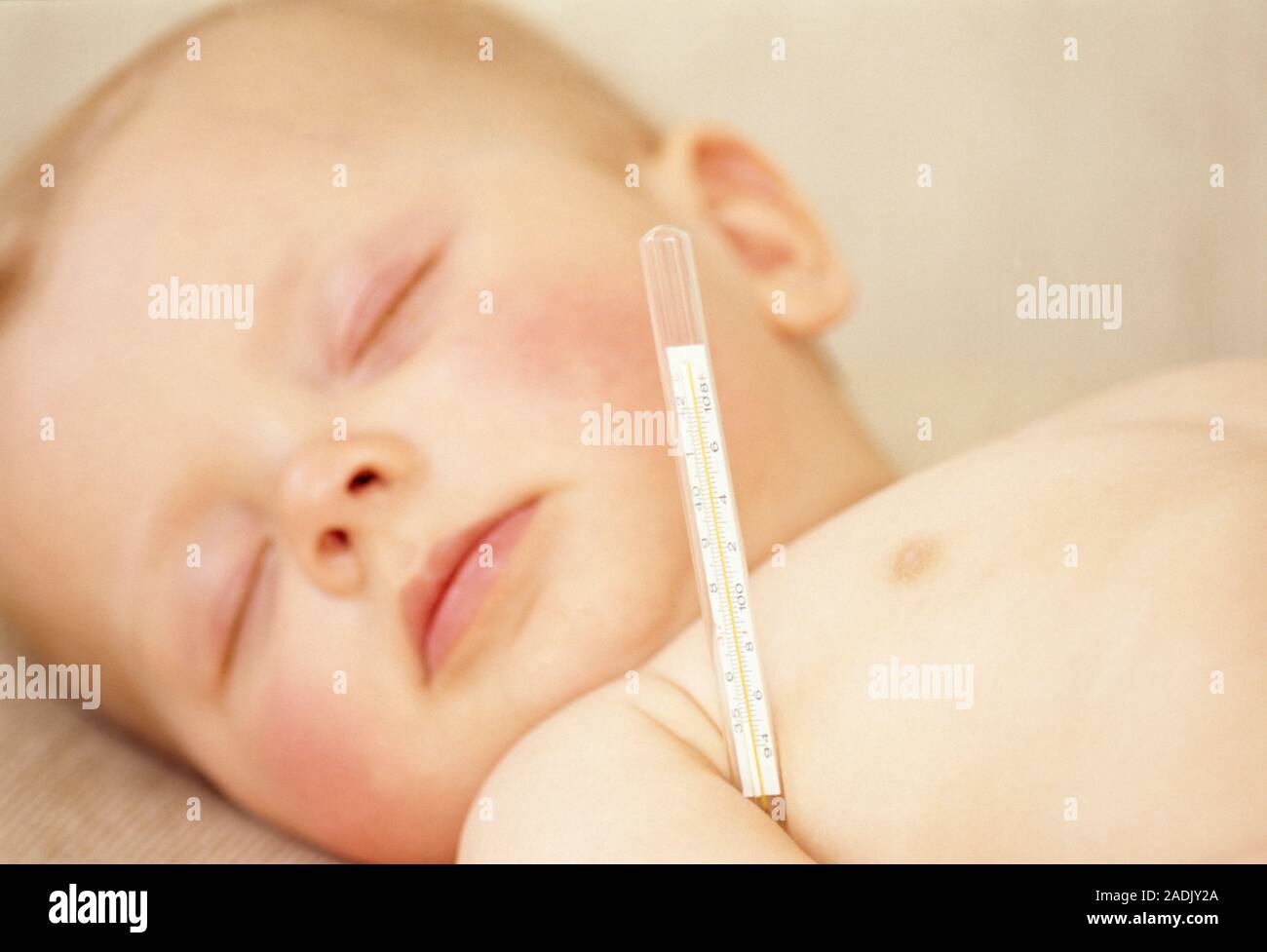 Taking baby's temperature. Sleeping 7monthold baby girl lies with a