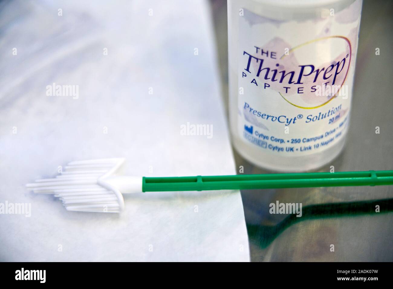 Smear test equipment. Close-up of a cytobrush and container of ThinPrep  smear test preservation solution. The cytobrush is used to take a sample of  ce Stock Photo - Alamy