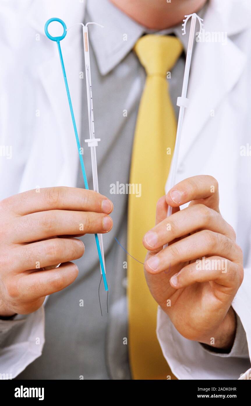 Intrauterine devices (IUDs) being held by a doctor. The IUD is a form