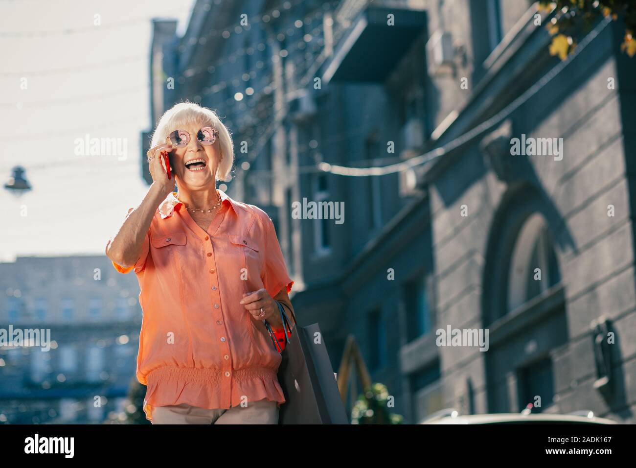 Pensioner looking excited during the phone talk Stock Photo