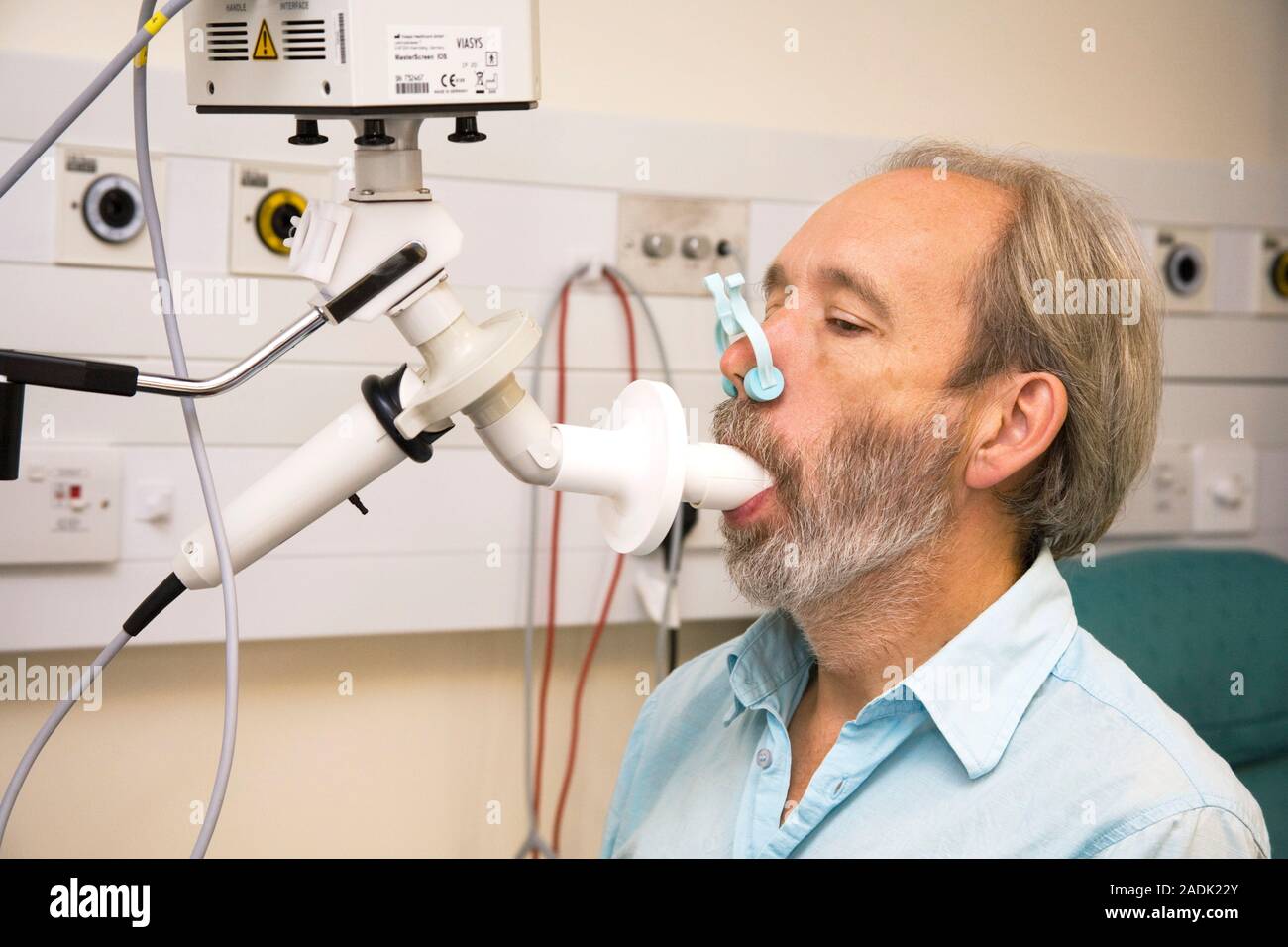 Lung function test. Healthy patient breathing into a spirometer during