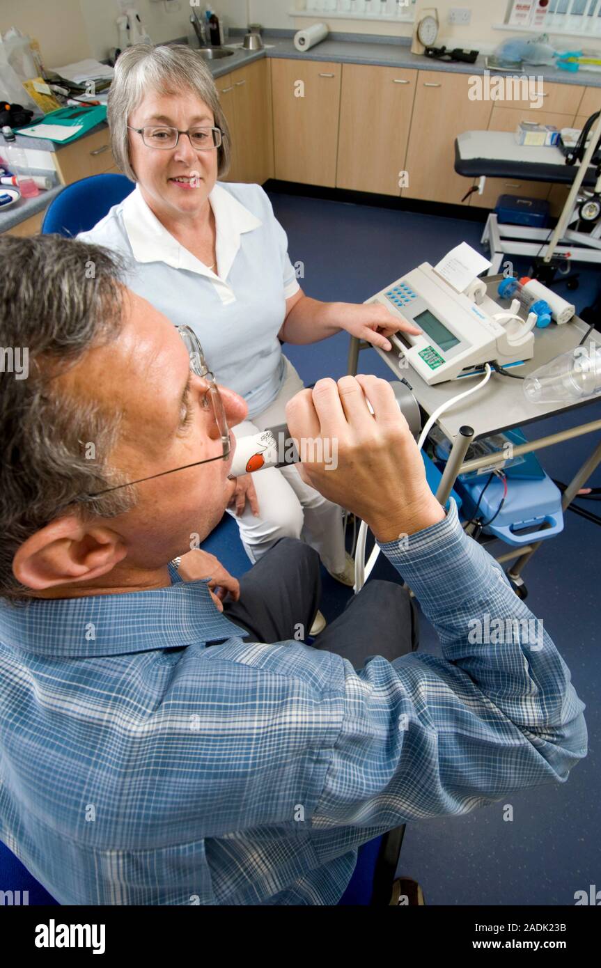 MODEL RELEASED. Lung function test. Patient breathing into a spirometer