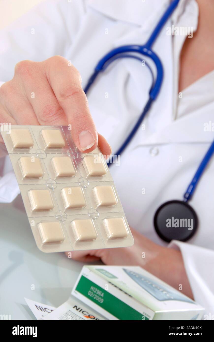 MODEL RELEASED. Smoking cessation. Doctor holding out a packet of