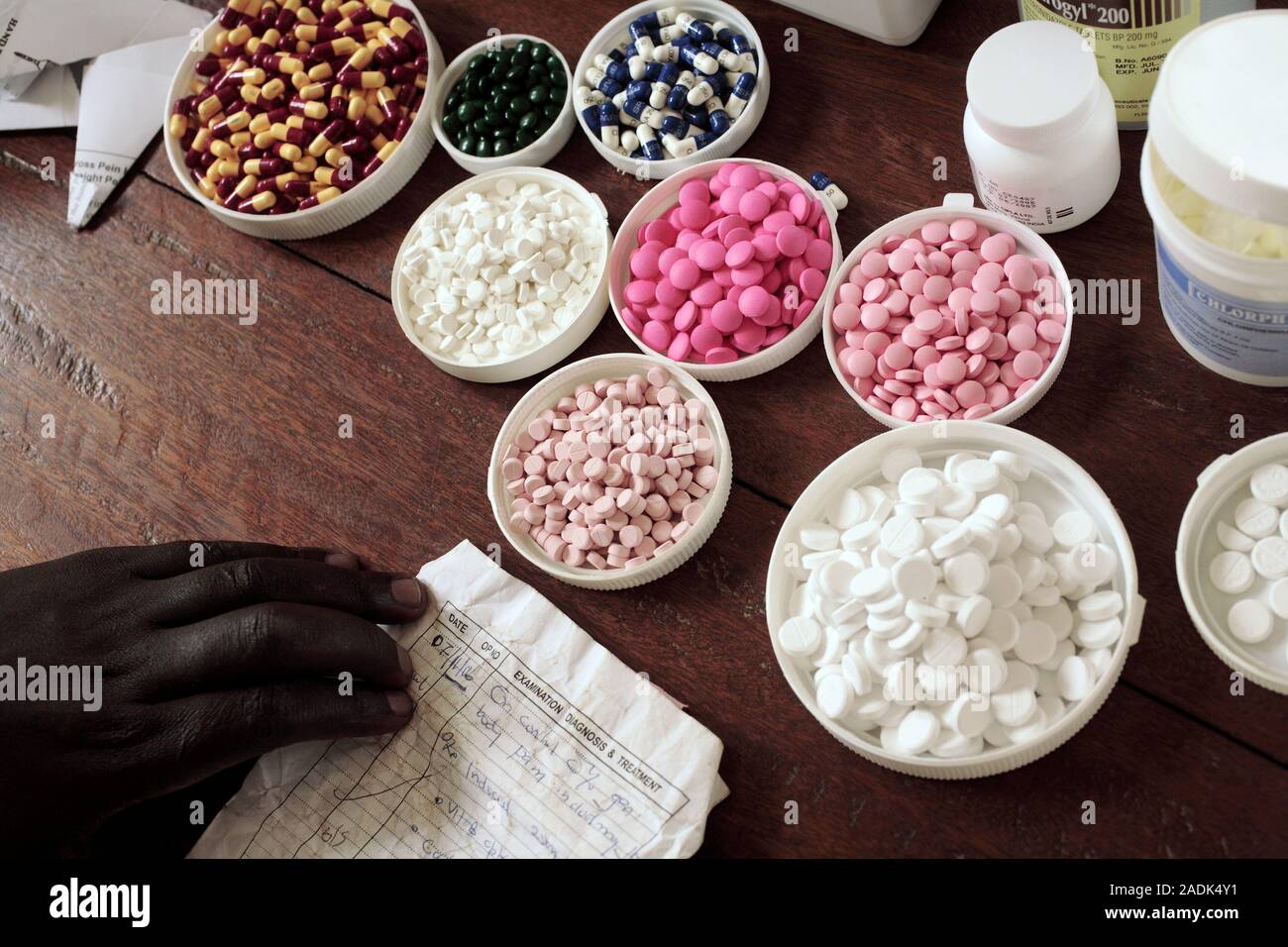 MODEL RELEASED. Dispensing medication. Bowls of tablets are seen with a medical record sheet