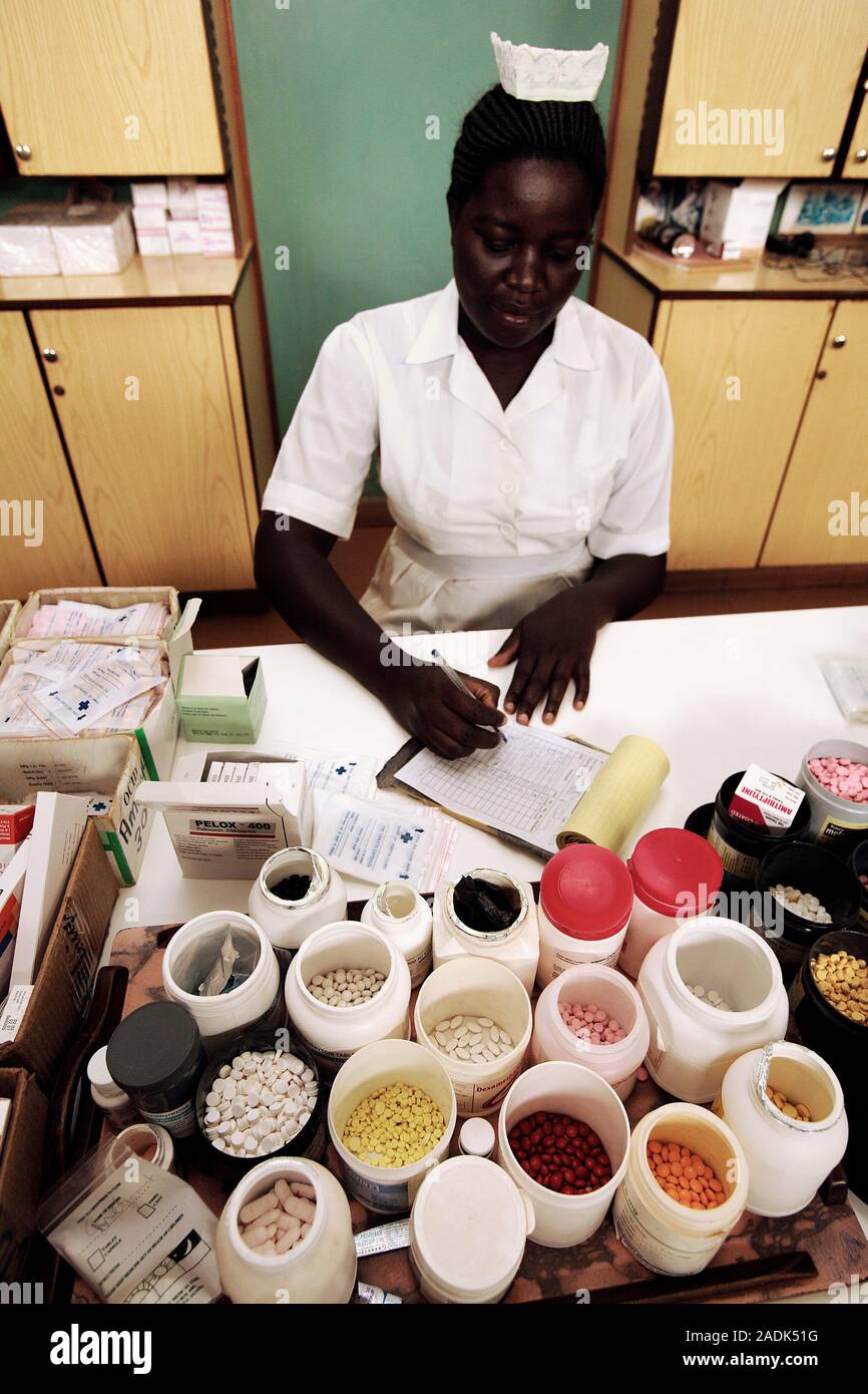 MODEL RELEASED. Dispensing medication. Pharmacist writing while various