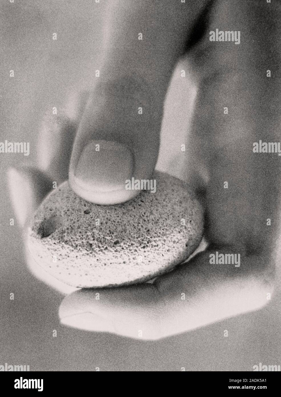 Pumice stone. Woman's hand holds a pumice stone, a light, porous