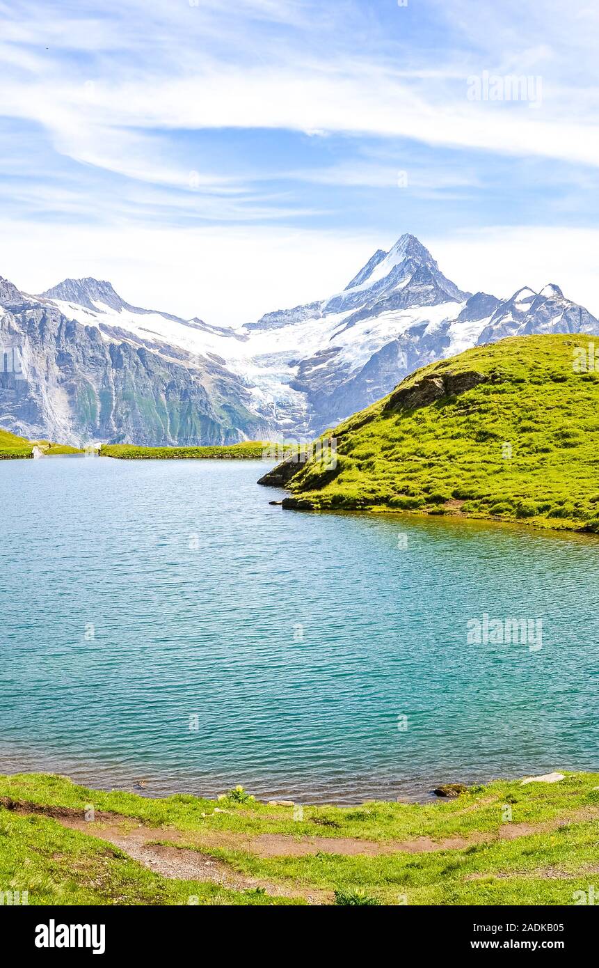 Amazing Bachalpsee lake in the Swiss Alps photographed with famous mountain peaks Eiger, Jungfrau, and Monch. Alpine lake and landscape. Alpine mountains, mountain range. Swiss nature. Stock Photo